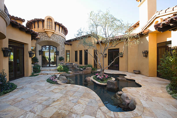 Paved Courtyard Garden With Pond Paved courtyard garden with pond in house against clear sky pool gate stock pictures, royalty-free photos & images