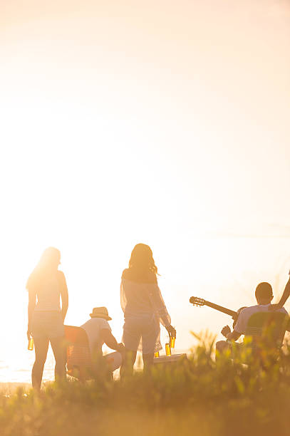 istock Friends on beach at sunset 477760115