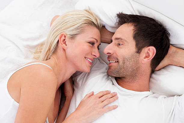 istock Loving couple lying in bed 477761468
