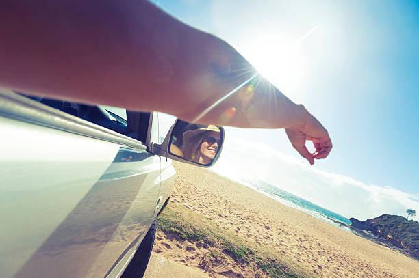 istock Woman pointing at beach from a car 477763041