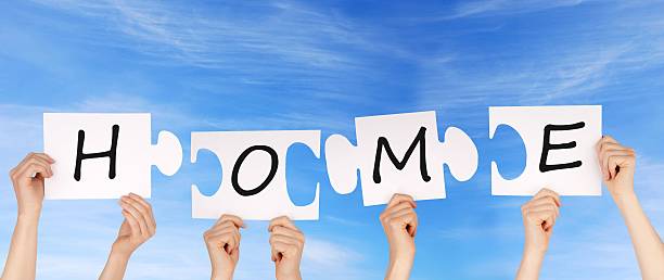 istock hands holding pieces of a puzzle with home 477766323