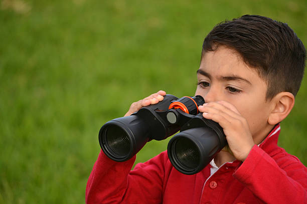 istock Child with binoculars in the park 477766711