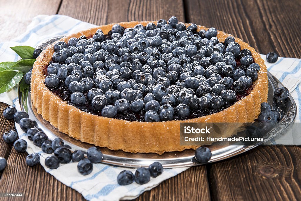 Fresh Blueberry Tart with fruits Blueberry Tart with fresh fruits on vintage wooden background Baked Stock Photo