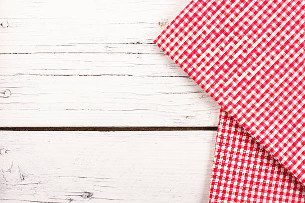 red checkered tablecloth on a white wooden board