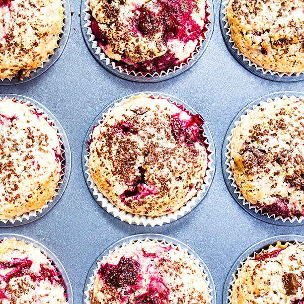 istock Homemade chocolate muffins with cherry  in baking tin  top view. 477771617