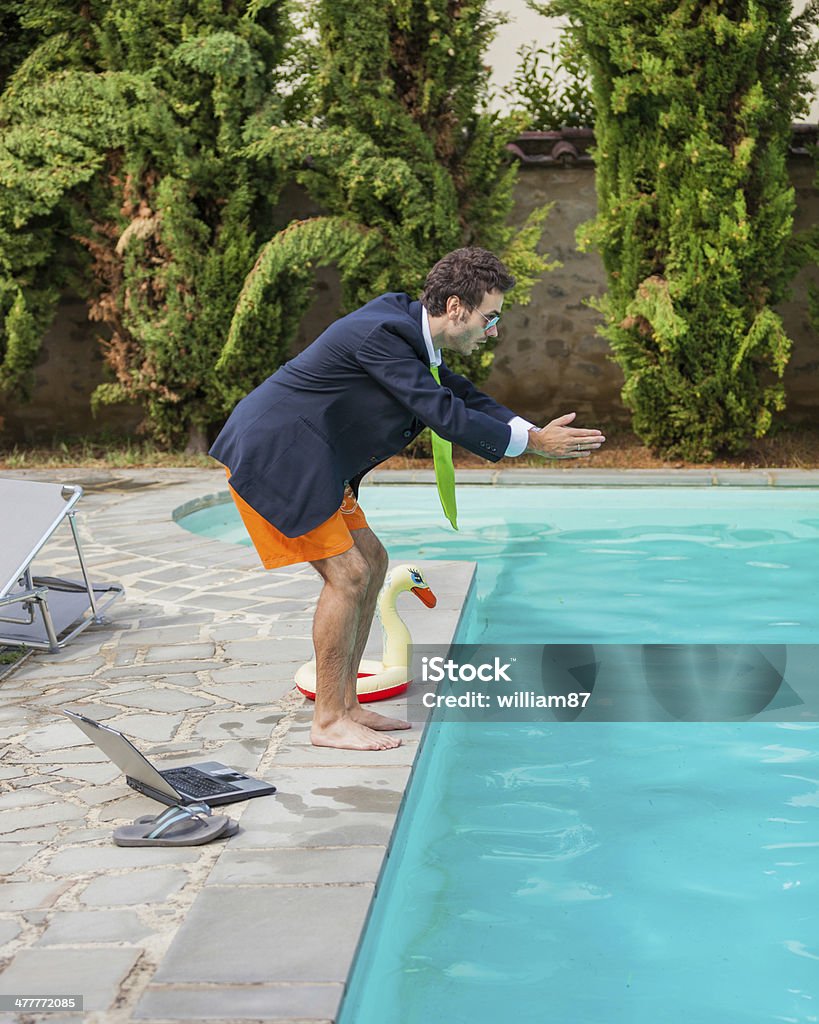 Funny Young Businessman with SwimmingTrunks Diving  into the Poo Funny Young Businessman with SwimmingTrunks Diving  into the Pool Adult Stock Photo