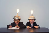 Two Young Boy Dressed in Suits and Thinking Caps