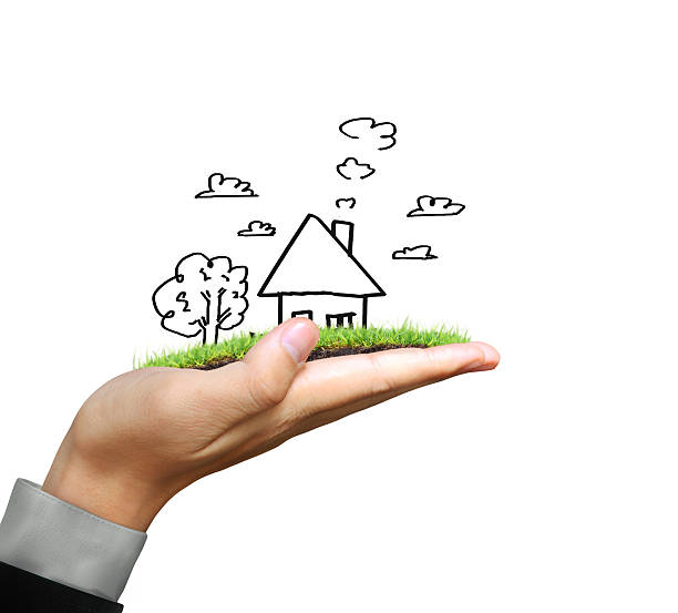 istock Businessman holding house model 477777386