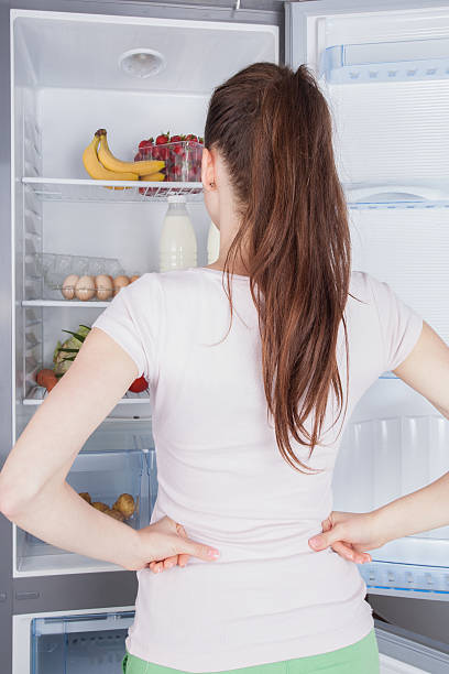istock Young woman craving food choosing 477777612