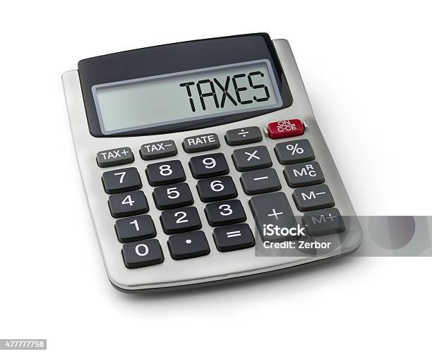 Calculator With The Word Taxes On The Display Stock Photo - Download Image Now - Tax Form, 2015, Analyzing