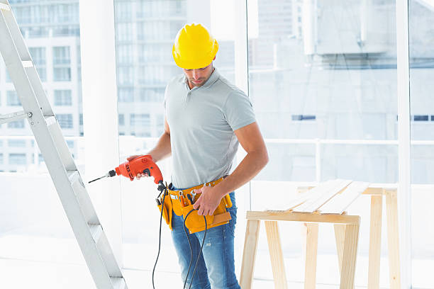 istock Repairman with drill machine in building 477777840