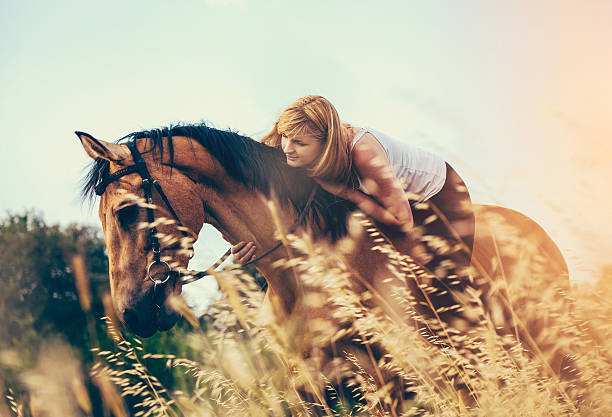 istock Young woman riding a horse in nature 477777982