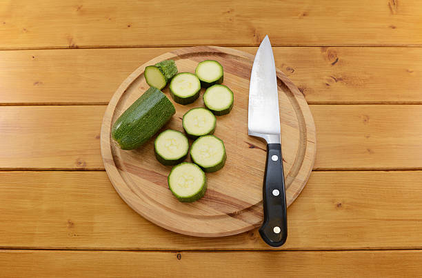 istock Courgette sliced with a knife on a chopping board 477778090
