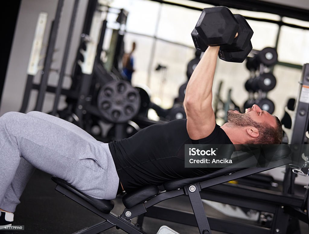 gym man Adult man with weight training equipment on sport modern gym 2015 Stock Photo