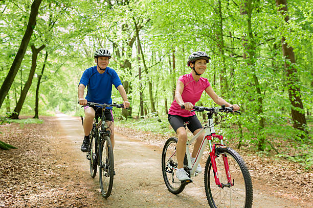 istock Active mature couple outdoors riding bikes in the nature 477779342