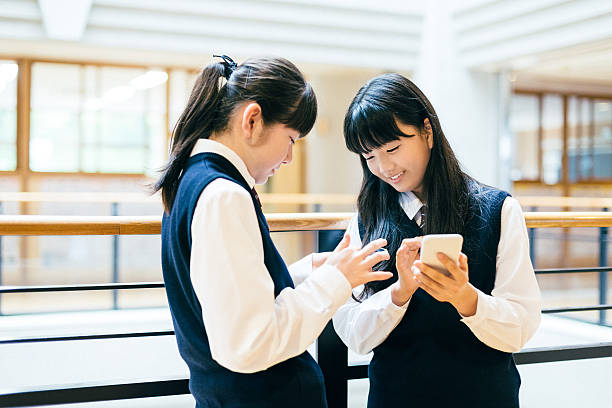 istock Japanese High School Girl Students using Smartphones at school 477780266