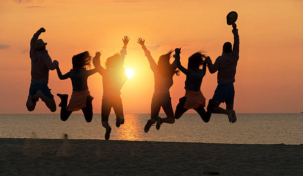 istock Group of People Celebrating on the beach 477780500