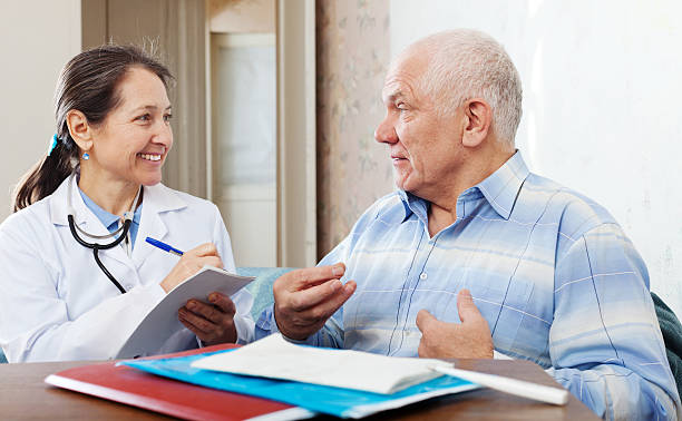 istock friendly mature doctor talks with  senior man 477783567