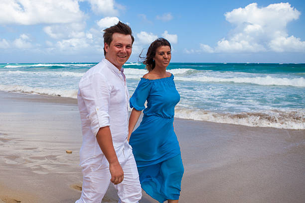 istock Beach couple walking on romantic travel. 477785694