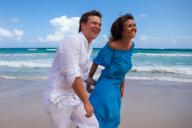 istock Beach couple walking on romantic travel. 477785714