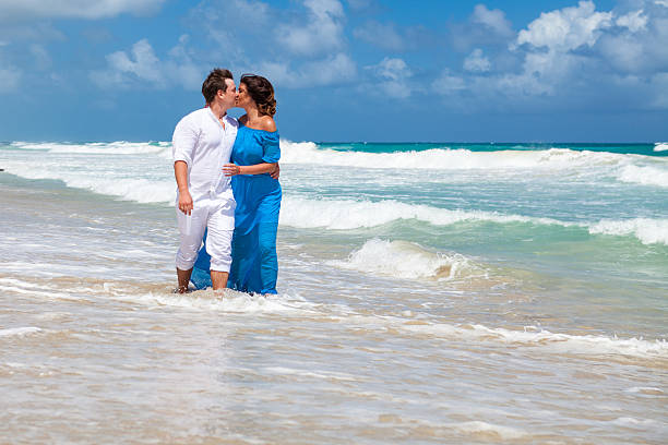 istock Beach couple walking on romantic travel. 477785900