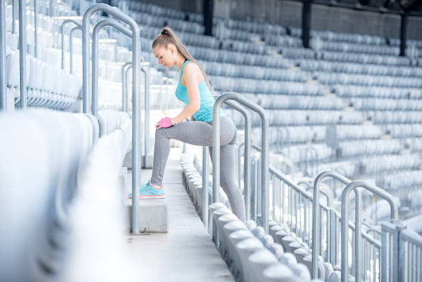 istock Female fitness trainer preparing for training, stretching and doing squats 477788254