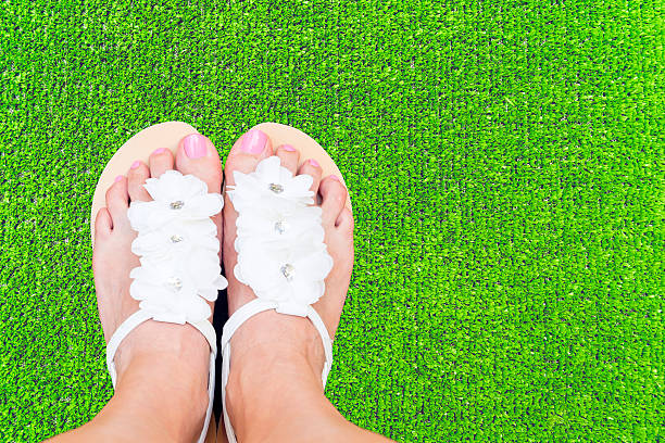 istock Woman feet on grass 477788820