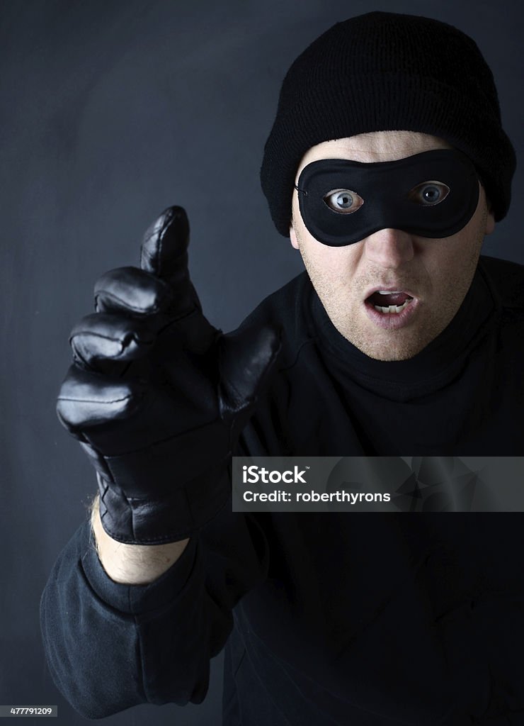 Thief grab A thief reaching out to seal in a dark setting Black Color Stock Photo