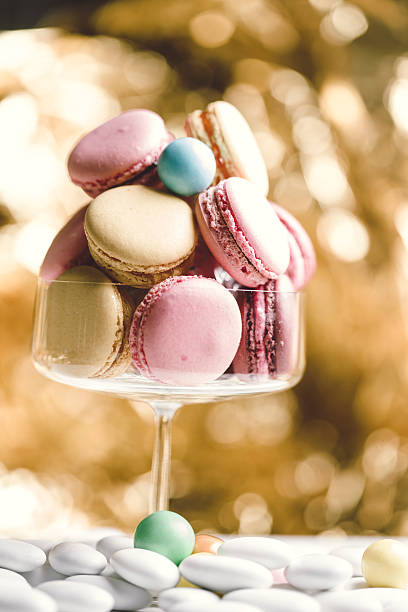 istock Macarons in glass, golden background 477795476