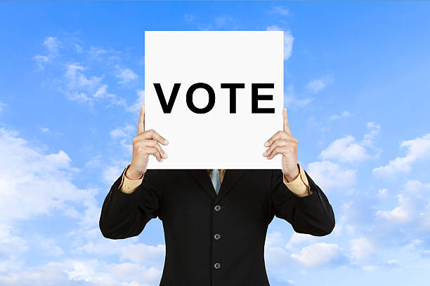 istock Businessman show wording VOTE on paper board 477795949