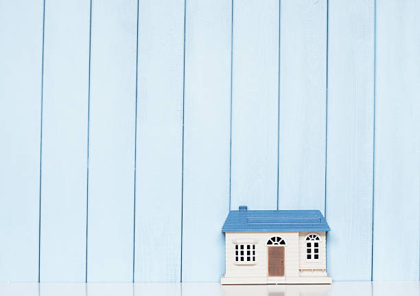 toy house toy house on the bookshelf on blue wooden background in the children's room interior of old house garret stock pictures, royalty-free photos & images