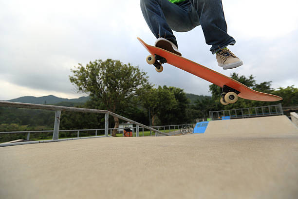 istock skateboarder legs doing a trickollie at skatepark 477803942