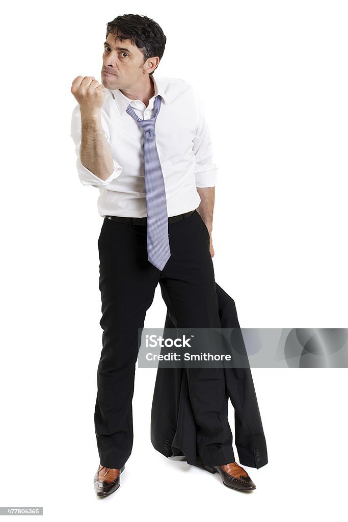 Enraged man making a threatening fist Enraged business man with his suit jacket in his hand making a threatening gesture with his fist and giving a belligerent look isolated on white Adult Stock Photo