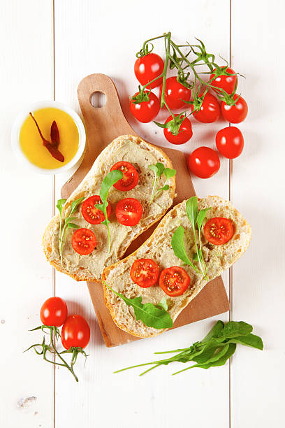 istock sandwich with cherry tomatoes and cream of avocado and arugula 477808580