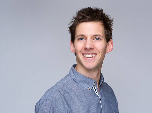 istock Smiling young man on gray background 477812915