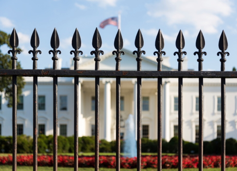 Main entrance of White House seen through railings at 1600 Pennsylvania Avenue Washington DC