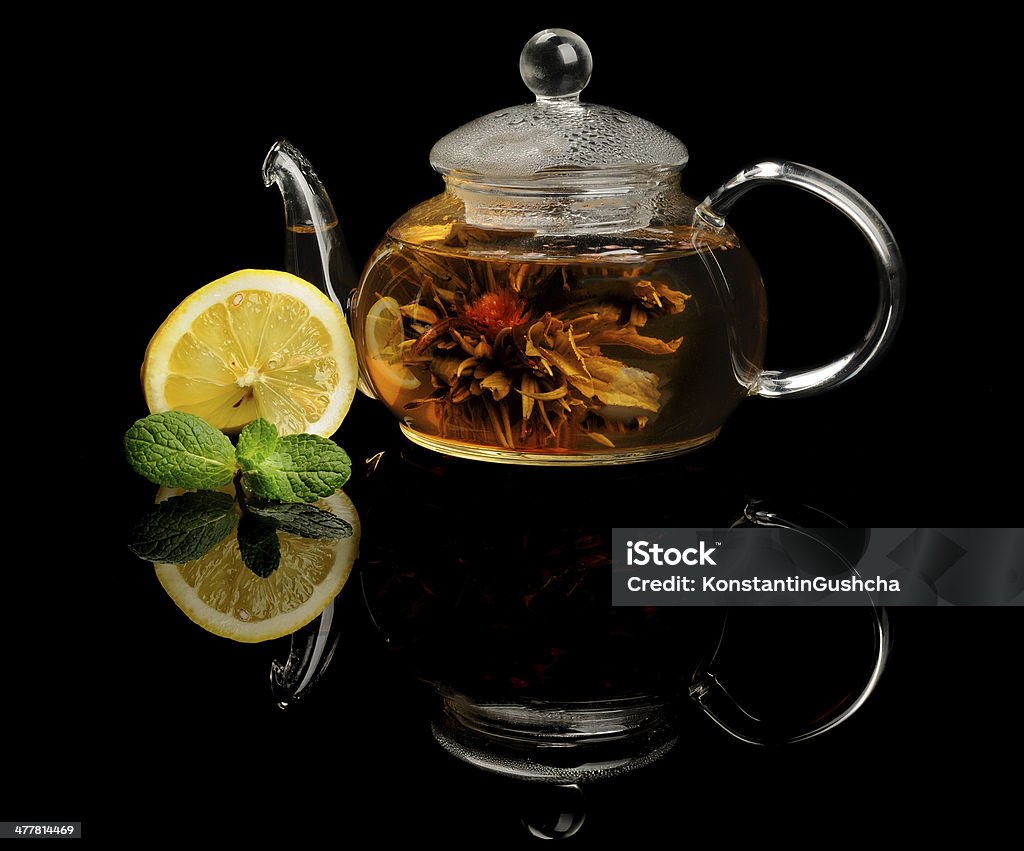 Blooming tea Blooming or flowering tea on black reflecting background Black Background Stock Photo