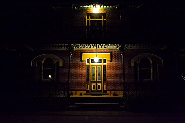 Homestead at Night Photograph of the front door of an Australian homestead late at night. haunted house stock pictures, royalty-free photos & images