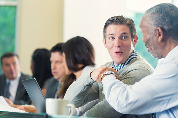 istock Diverse professional coworkers fist bumping during seminar or conference 477815146