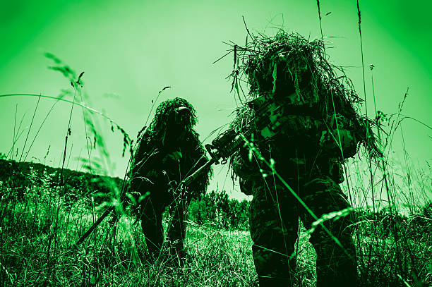 Infrared Night Shot of Sniper and Spotter Soldiers Hiding stock photo