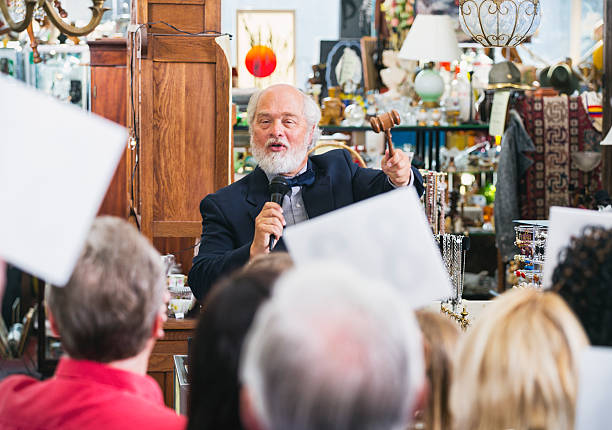 Auction Crowd An excited auctioneer at a live auction. auction stock pictures, royalty-free photos & images