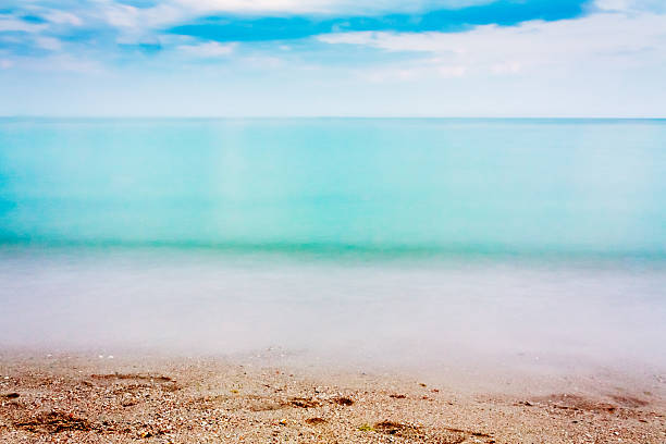 Long Exposure Of Sea Ocean Water Beach Long Exposure Of Sea Ocean Water Beach Background ocean beach papua new guinea stock pictures, royalty-free photos & images