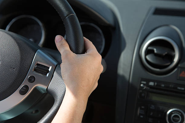 istock Hand on the steering wheel of a car 477820445