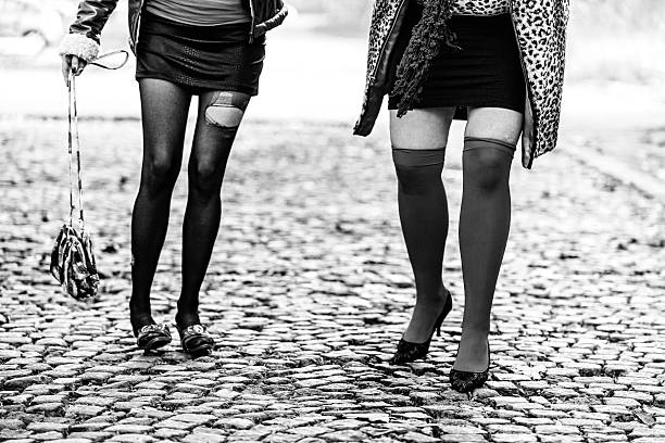 istock Prostitutes walking on cobblestone street 477820697