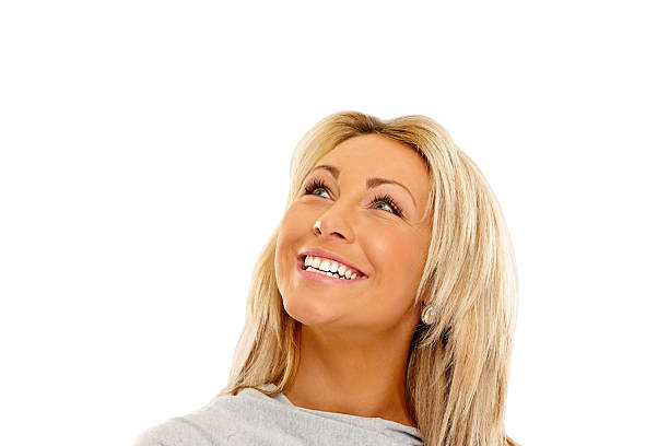 istock Attractive young woman looking up smiling 477823343