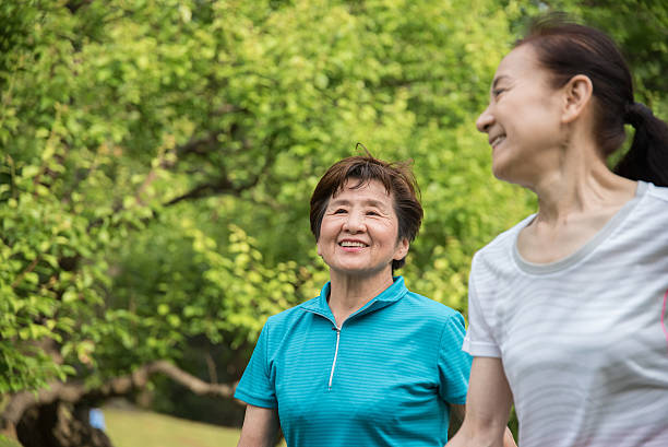 istock Elderly women enjoying walk in the park 477823528
