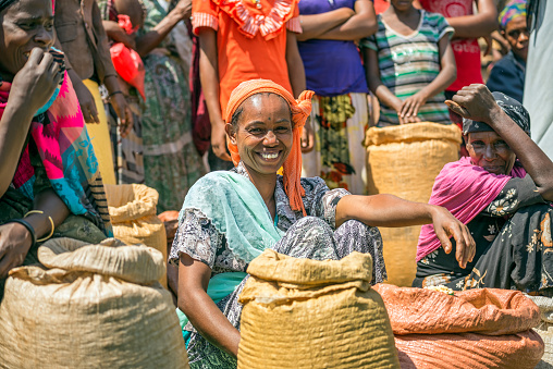 Jimma, Ethiopia - May 2, 2015 : Ethiopian woman selling crops in a local crowded market.
