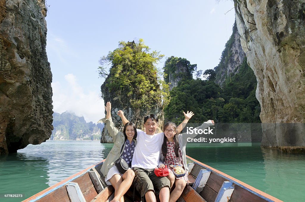 Family on boat in Khao Sok National Park, Thailand Happy family boat trip on summer vacation in Ratchaprapha Dam, Khao Sok National Park, Surat Thani Province, Thailand ( Guilin of Thailand ). Family Stock Photo