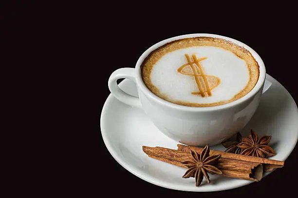 Photo of dollar sign on latte art coffee cup