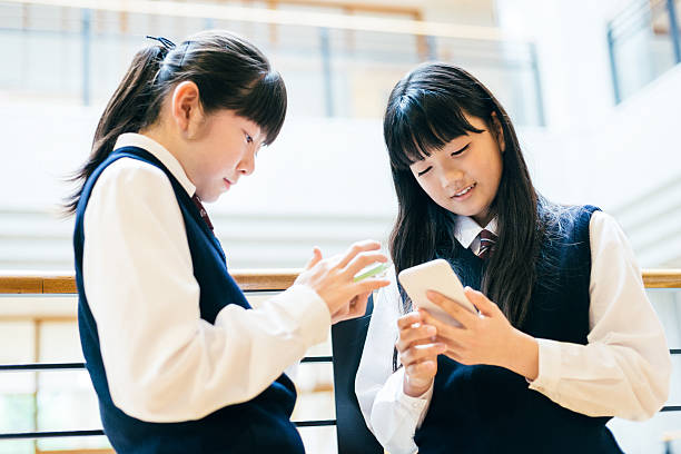 istock Japanese High School Girl Students using Smartphones at school 477827664